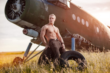 A man in front of a plane.