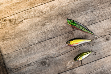 Fishing lures on a wooden background