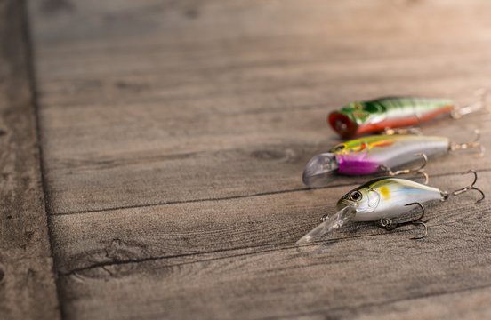 Fishing lures on a wooden background