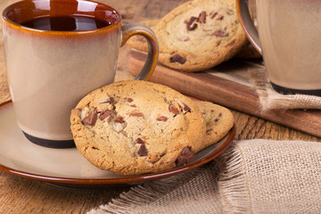 Chocolate chip cookies and cup of coffee on a plate