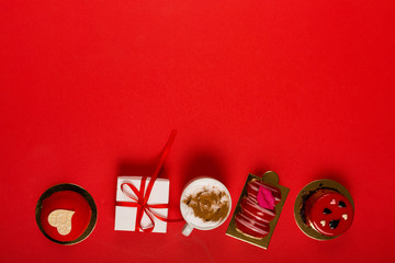 Present and deserts on a bright red background with a copy space