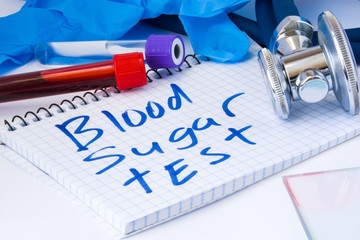 Blood sugar test count procedure biochemical analysis of blood. Laboratory test tubes with blood, stethoscope, smear or film and gloves are near note with text sugar test on table in doctor office