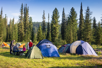 Family Enjoying Camping Holiday In Countryside