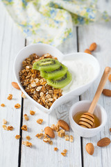 breakfast with granola on wooden surface