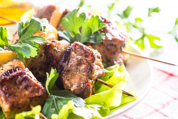 Grilled shish kebab or shashlik on white.