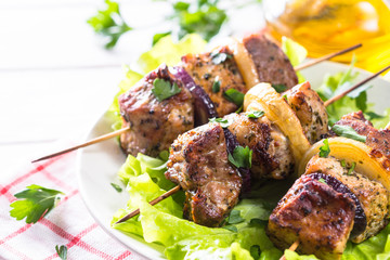 Grilled shish kebab or shashlik on white.