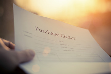 Fill in the purchase items in an order form,Close up of purchase order form with pen / selective focus