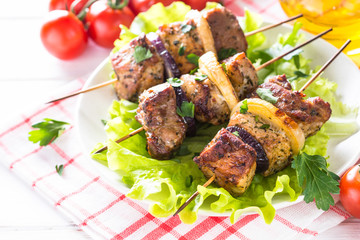 Grilled shish kebab or shashlik on white.