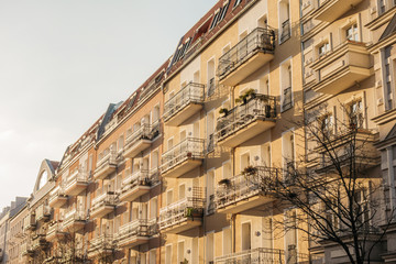 Fototapeta premium yellow beautiful apartment houses with white balcony