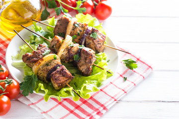Grilled shish kebab or shashlik on white.