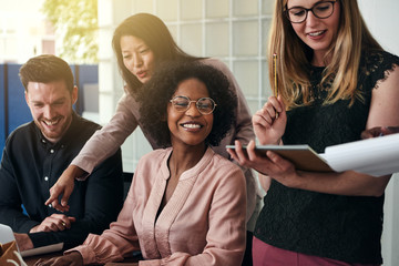 Smiling group of diverse businesspeople working in an office