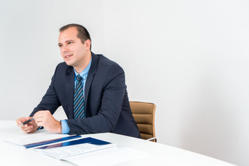 Business man executive holding pen, wearing tuxedo and tie. Confident Senior Business leader