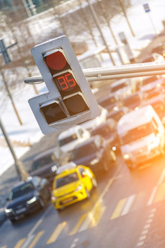Cars stand at an intersection until the traffic light shows red