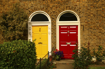 Fototapeta na wymiar Two vintage Georgian doors yellow and red colors in Dublin,Ireland