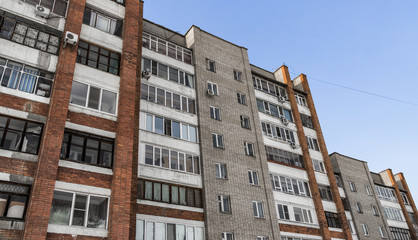 Fototapeta premium Large residential building. Apartment block. Modern architecture. Apartment building. Grunge. Brick apartment house