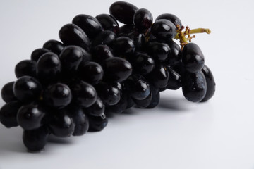 Black bunch of grapes isolated on white