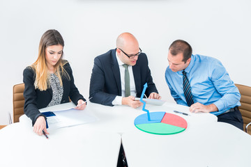 A business team of three sitting in office and planning work. Using laptop to make business strategy. Startup in developement.