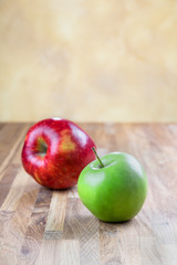 two ripe juicy apples lying on an oak table