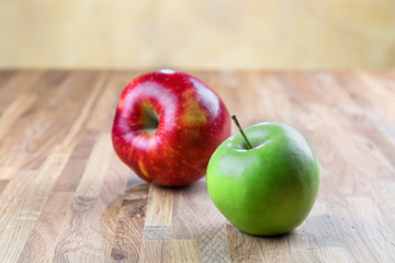 two ripe juicy apples lying on an oak table
