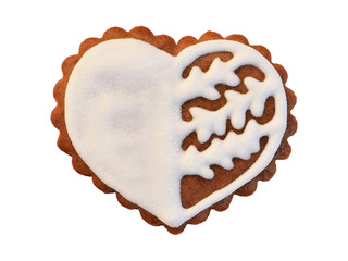 Gingerbread in the shape of heart with white glaze, isolated on white background