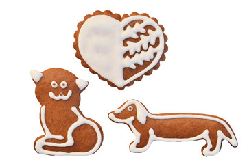 Cat loves dog - gingerbread in a shape of heart, cat and dog isolated on a white background