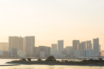 Cityscape and sea in sunset.