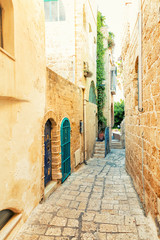 Beautiful narrow street with paving stones in the old city in summer