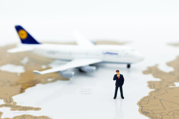 Miniature business people : businessman with plane. Image use for business travel, business trip travel advisory agency of transportation concept.