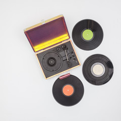 Old vinyl turntable player with record isolated on a white background