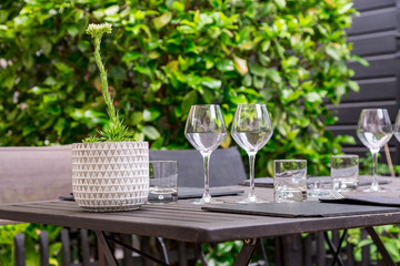 cutlery of a gourmet restaurant table with greenery in the background