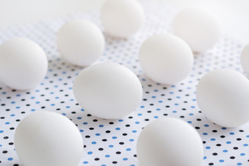 White eggs on polka dot fabric