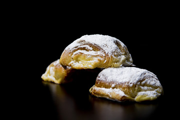 Traditional Mexican sweet bread with powdered sugar, elegantly presented in a dark food photography...