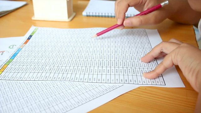 Hands of woman reading number table account working concept
