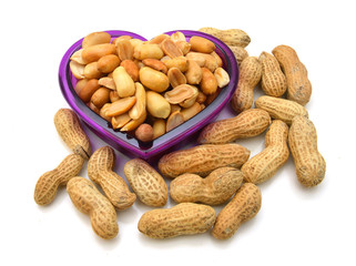 Peanuts in bowl on white background