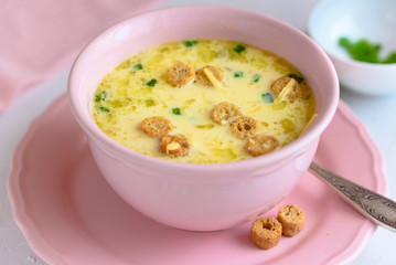 Cheese soup with croutons and fresh herbs.