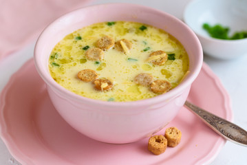 Cheese soup with croutons and fresh herbs.
