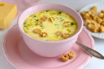 Cheese soup with croutons and fresh herbs.