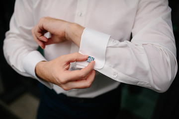 Fototapeta na wymiar Businessman in white shirt buttons cufflinks