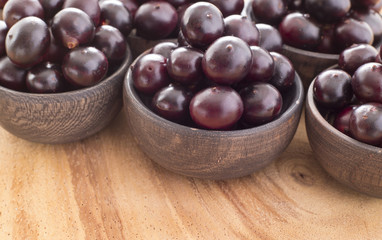 Acai fruits in wooden bowls - Euterpe oleracea
