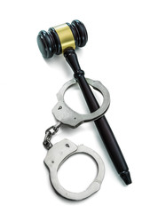 Handcuffs and Judge Gavel isolated on white