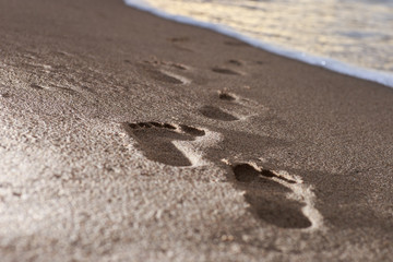 Human footprints on the sand beach. Travel vacations concept.