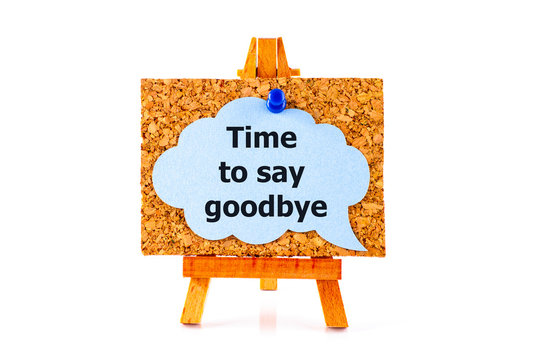Blue speech bubble with phrase Time to Say Goodbay on corkboard on wooden easel.