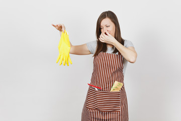 Young sad upset tired shocked housewife in striped apron with cleaning rag in pocket isolated on...