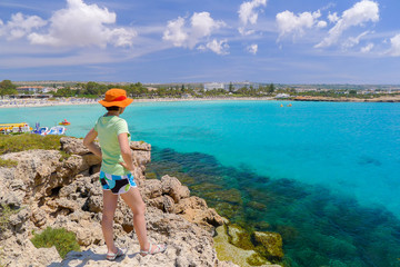Young woman tourist looking at beach of Ayia Napa, Cyprus island