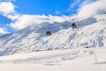 Two gondola cars in Obergurgl-Hochgurgl mountain ski area during beautiful sunny winter day, Austria