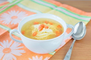Traditional chicken broth with carrot.