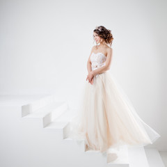 Fototapeta na wymiar Concept of bride going towards future happiness. Beautiful girl in a wedding dress.