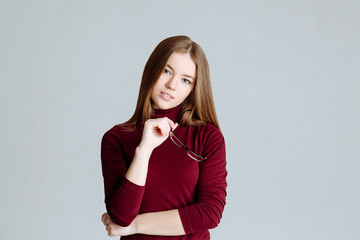 body language and emotion. The young attractive blonde looking at camera with serious or pensive...
