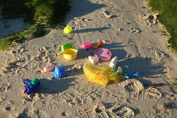 colorful toys in the sand of a beach