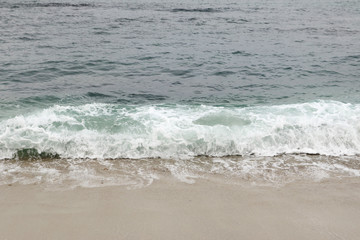 Fototapeta na wymiar seashore with sand and waves